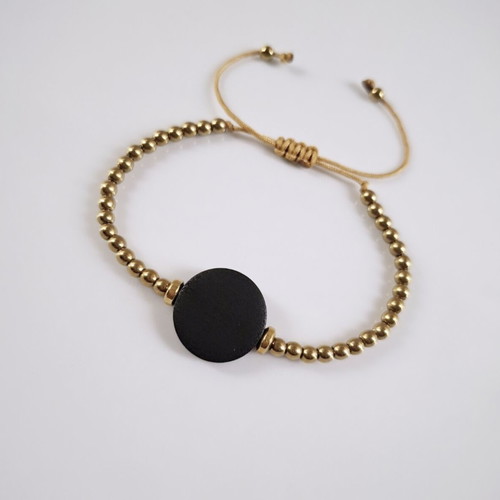 Bracelet with gold beads and black wooden adjustable element