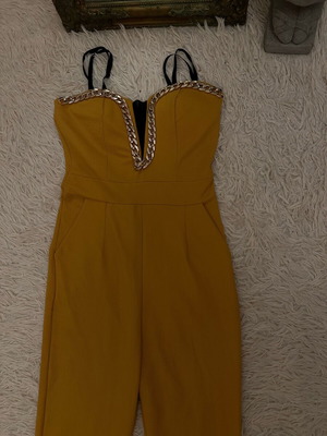 One-piece jumpsuit used with gold details and mesh neckline