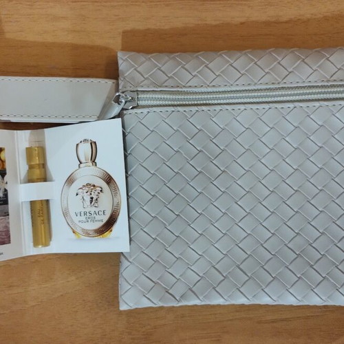 Everyday beige toiletry bag with woven texture and Versace Eros Pour Femme perfume sample