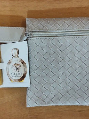 Everyday beige toiletry bag with woven texture and Versace Eros Pour Femme perfume sample