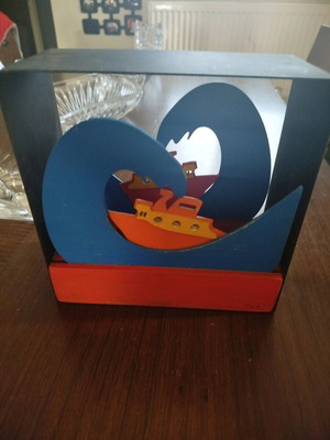 Decorative metal tealight holder used, ship on the wave