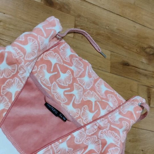 Pink cardigan used with white patterns and zipper, size L
