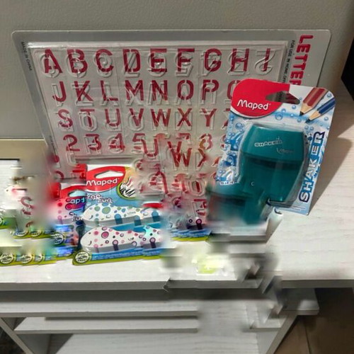Maped school supplies set with alphabet stencil, erasers, sharpener