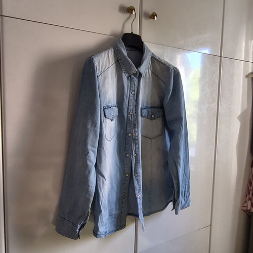 Light blue women's denim shirt with subtle polka dots