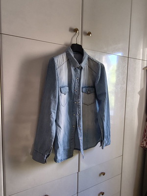 Light blue women's denim shirt with subtle polka dots