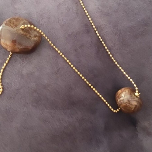 Faux necklace with long gold chain and large brown stones