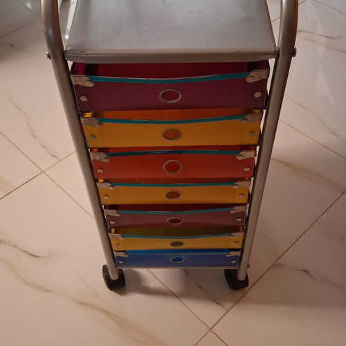 Modern wheeled drawer unit used with seven colorful plastic drawers