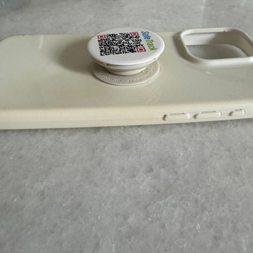 iPhone 15 Pro Max white case used with finger grip holder