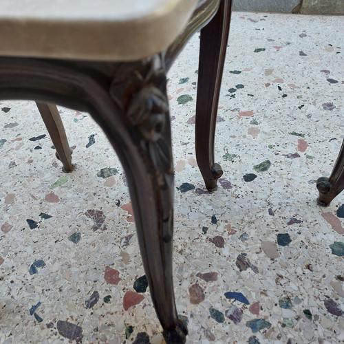 Vintage side tables pair with natural marble used