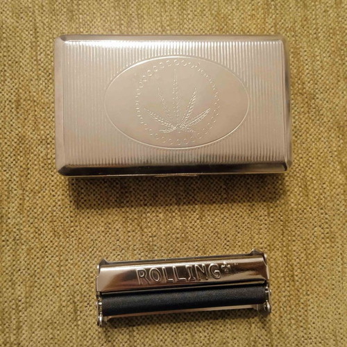 Tobacco case and metal cigarette roller used