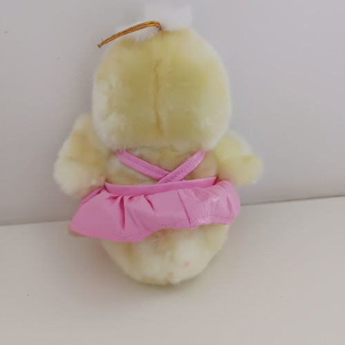 Plush duck with pink dress and sound button