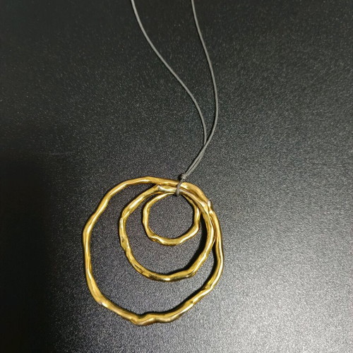 Long necklace like new, gold color with brown cord