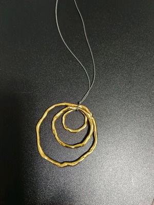 Long necklace like new, gold color with brown cord