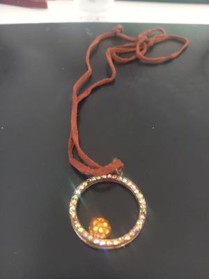 Pendant like new with subtle designs, black and gold