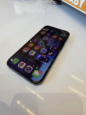 iPhone 15 Pro with case and 120W charger