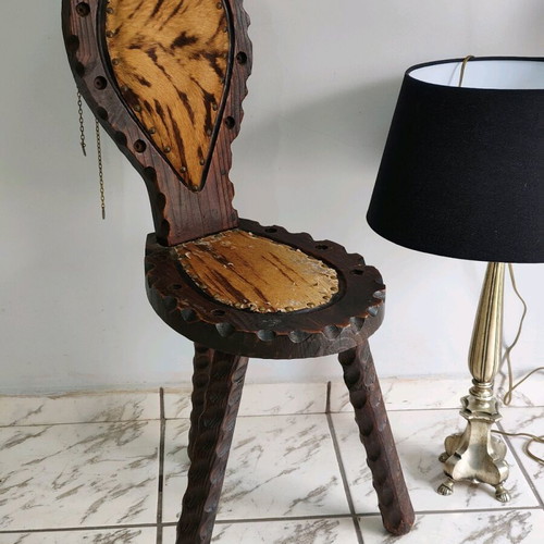 Spanish rustic chair used with three legs and animal leather from the 1960s