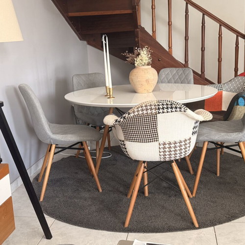 Modern dining set with round white lacquer table and fabric chairs used