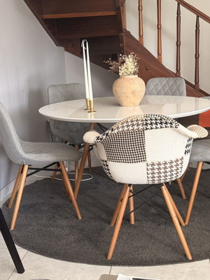 Modern dining set with round white lacquer table and fabric chairs used