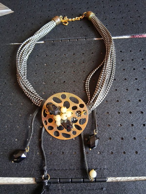 Necklace used 48cm black and gold with central motif