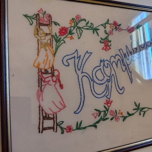 Framed embroidery with Kalimera and female figure, like new