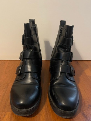 Black ankle boots used with straps and buckles