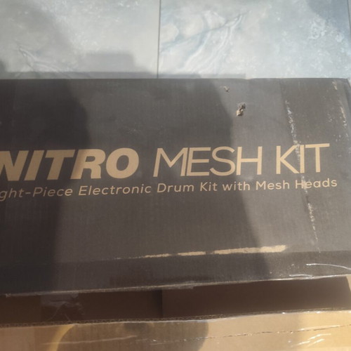 Alesis Nitro Mesh Kit electronic drums with Sony headphones and drumsticks holder