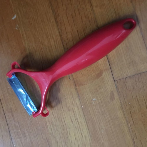 Red peeler new with thick handle made of durable plastic