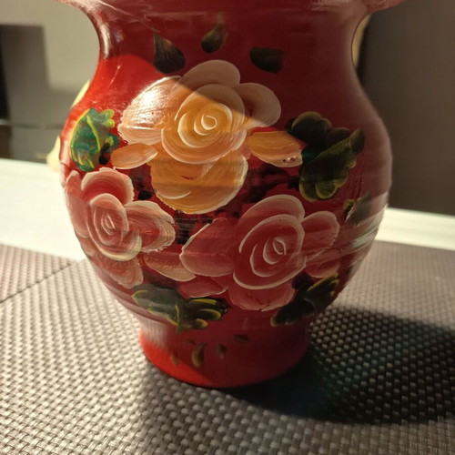 Handmade traditional clay vase with painted flowers