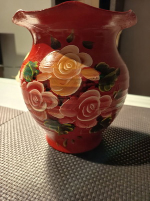 Handmade traditional clay vase with painted flowers