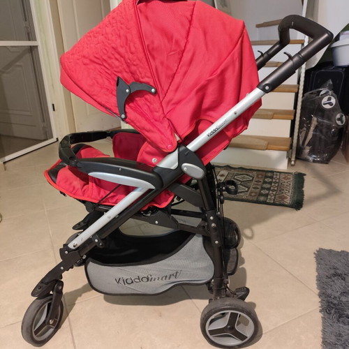 Kiddo Smart Deluxe stroller used with footmuff and changing bag, red