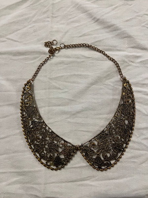 Collar-shaped necklace used, gold color with designs