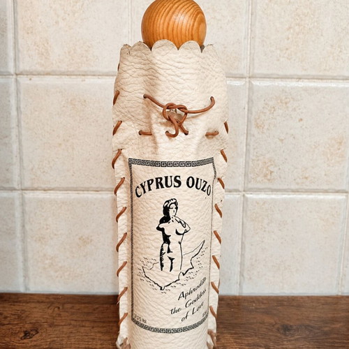 Decorative Cyprus Ouzo bottle cover with wooden lid like new