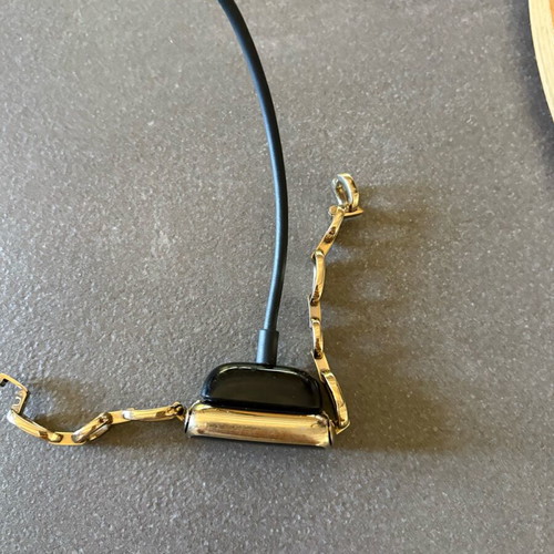 Fitbit Luxe smartwatch used with charger and case