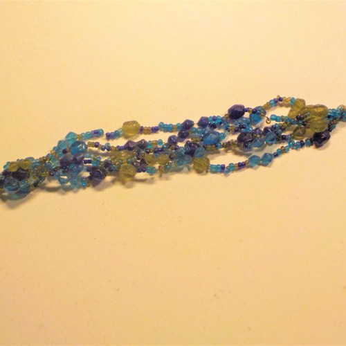 Bracelet with clasp and six rows of blue, light blue, and green beads