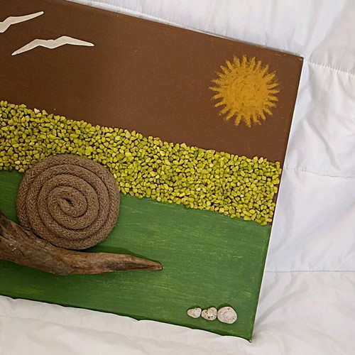 Handmade canvas art with snail and decorative stones