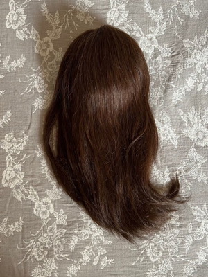 Wig used with postiz extensions made of natural dark brown hair