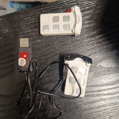 Syma drones used with controllers, two batteries and extra propellers