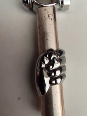 Vintage gas lighter used with hand holding hammer design