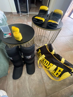 Kick boxing equipment used with gloves, wraps, shin guards, mouthguard, and bag