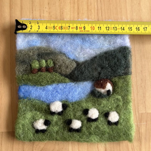 Handmade wool felt landscape picture with sheep