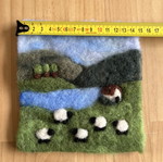 Handmade wool felt landscape picture with sheep