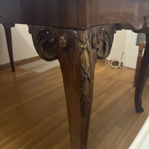 Wooden dining table used with carved legs and metal details