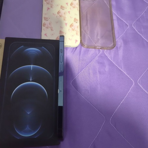 iPhone 12 Pro Max Pacific Blue 128GB like new with 7 cases and screen protectors
