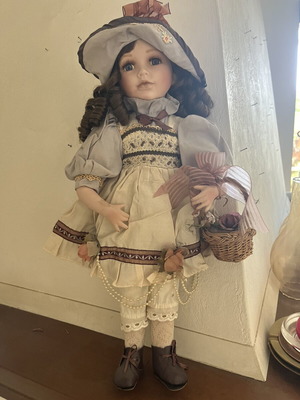 Porcelain doll with hat and basket, 52 cm