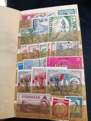Stamp album used with various stamps from around the world