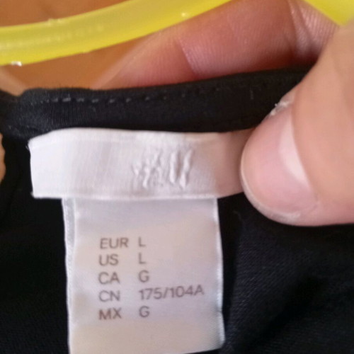 H&M black blouse with shoulder cutouts and cords, new
