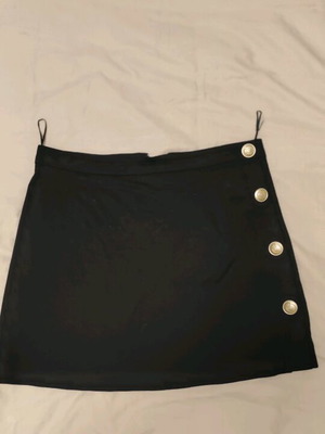 Mini black skirt with gold buttons and crown design, like new, size Large Anel