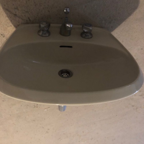 Beige sink used with faucets