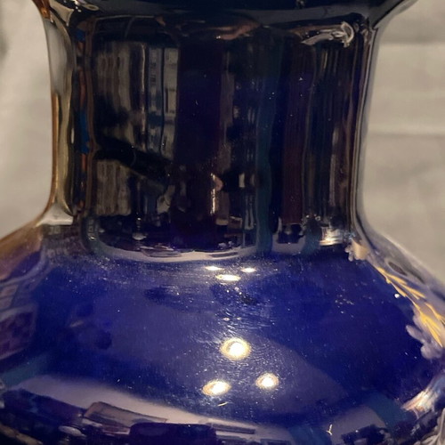 Old porcelain vase dark blue with gold designs used