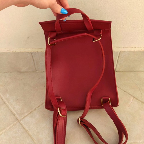 Red backpack used with broken zipper and mark